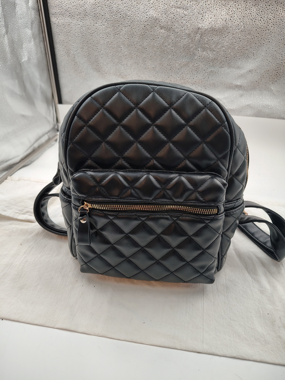 Quilted Black Mini Backpack with Gold Zip Accent